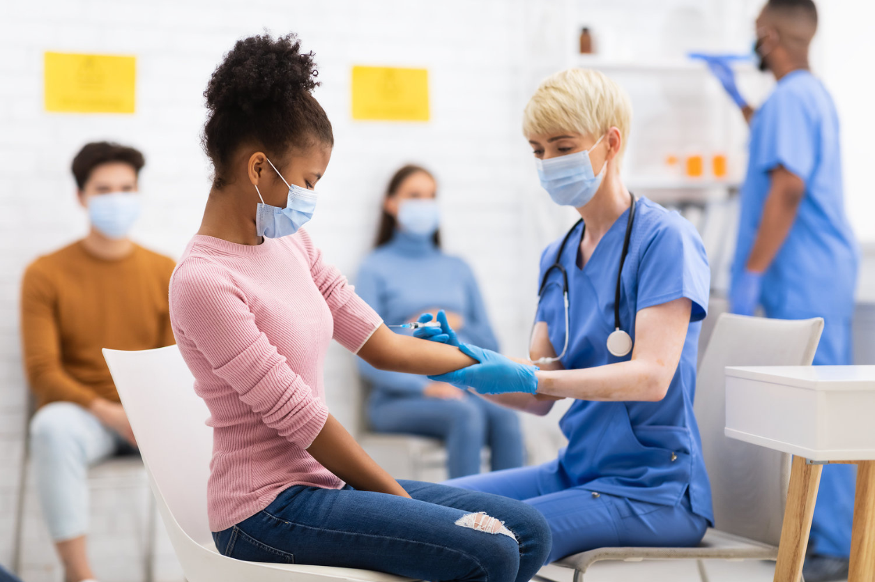 Nurse administering a vaccine injection to an adult patient at Servant Express Care Indianapolis