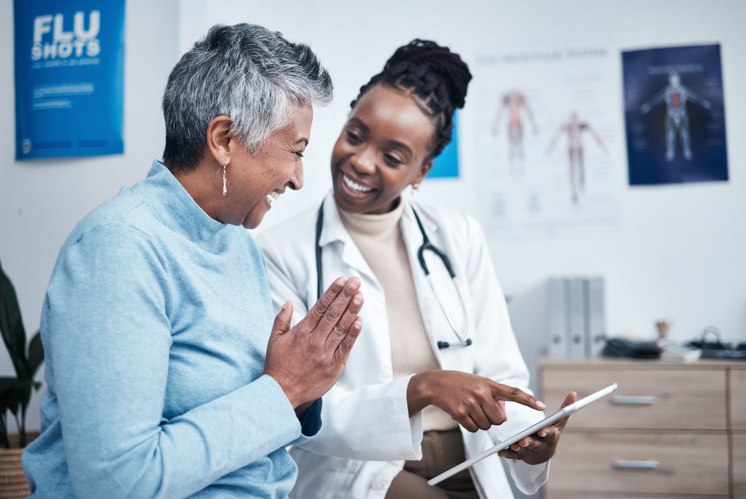 Primary care physician reviewing patient records during a wellness visit in Indianapolis